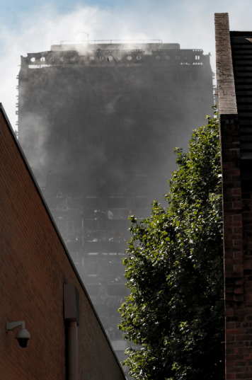 An image of the Grenfell tower with smoke engulfing the tower.